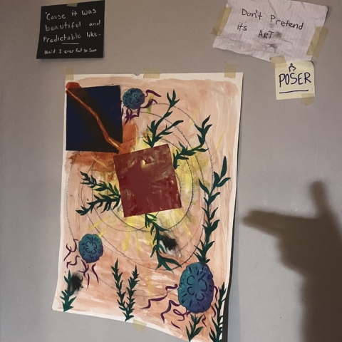 A painting with plants growing from all angles with three jellyfish scattered throughout. It is taped to a white wall with painters tape and a shadow of a hand making a pointing gesture. Other papers are hung up around it with different text.